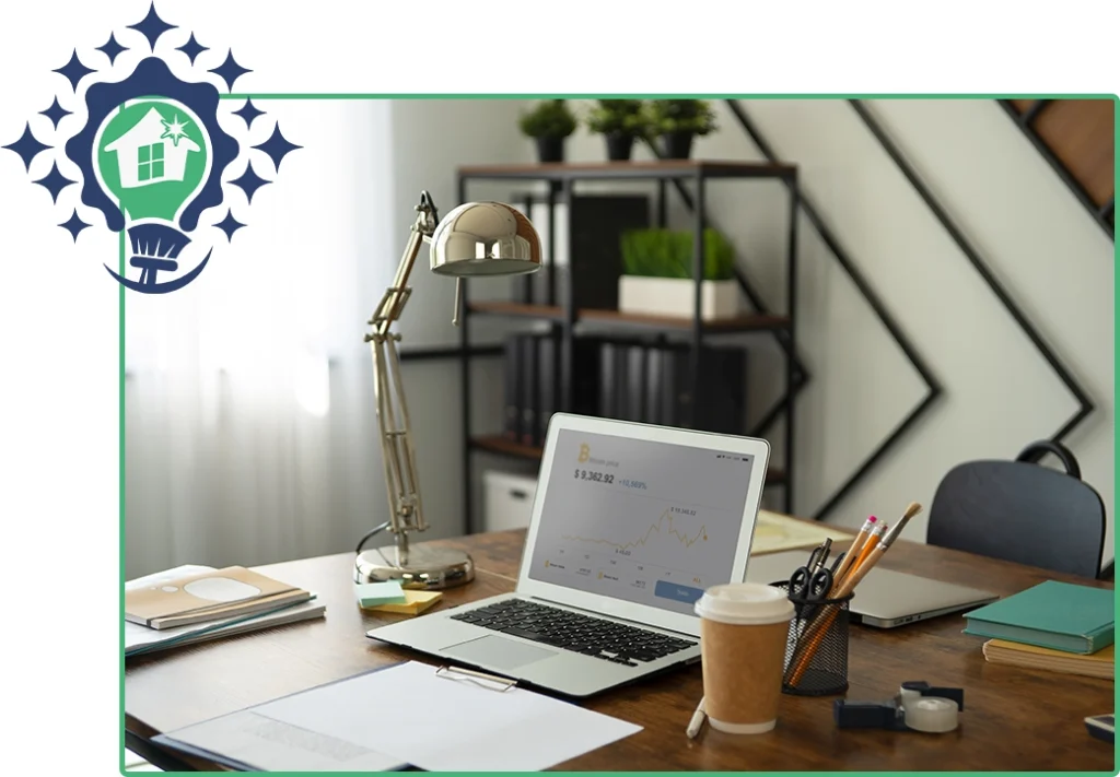 A tidy home office desk with a laptop, lamp, and coffee, maintained by a professional residential cleaning service.